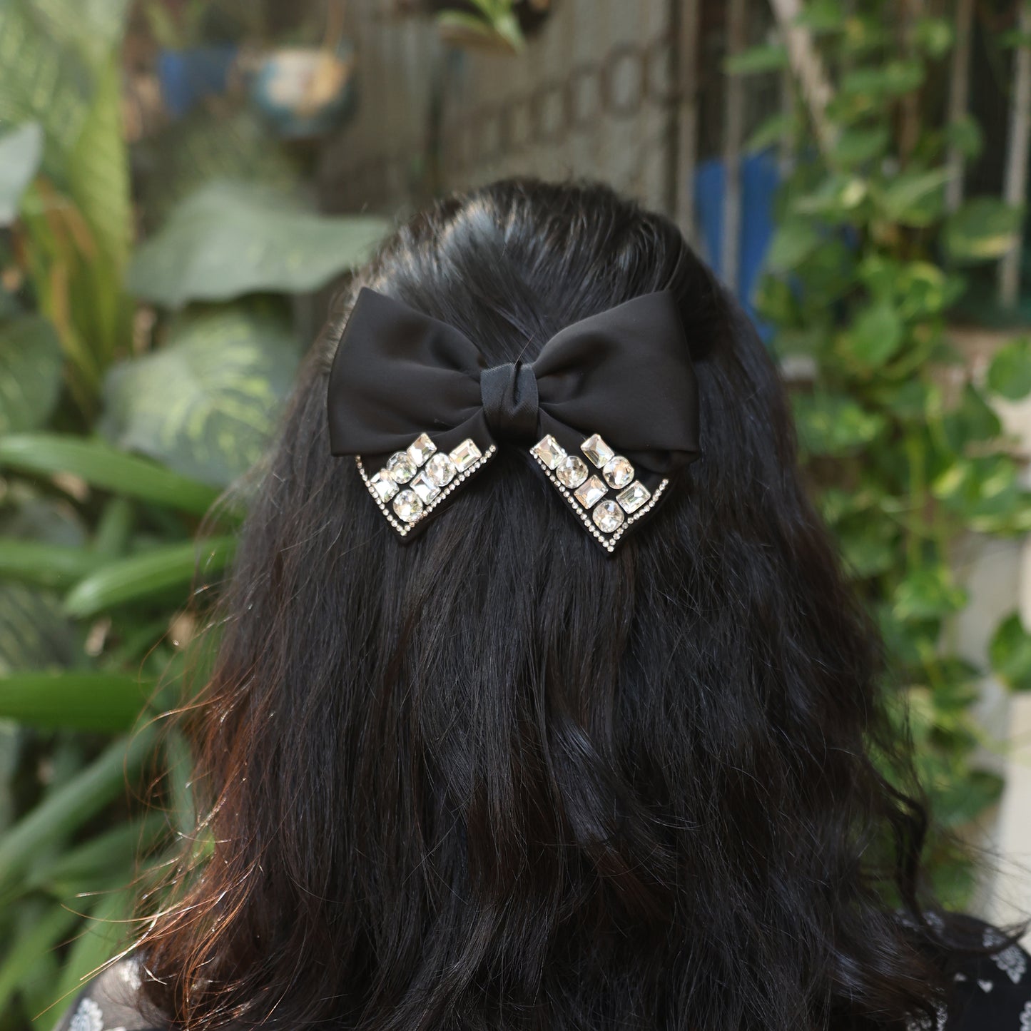 Studded Elegant Satin Bow Clips in black worn on long dark hair with decorative rhinestones