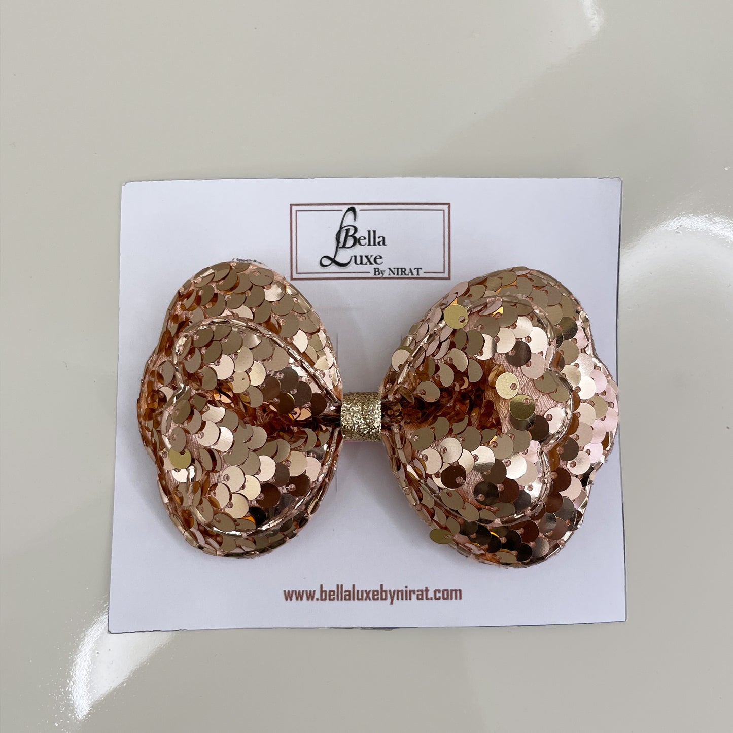 Rose gold Vibrant Sequined Bow Clips with large sequins on white Bella Luxe card