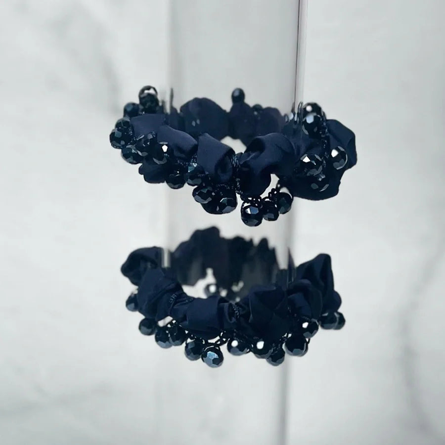 Black crystal studded hair ties with shiny beads and fabric detailing for stylish hair accessories