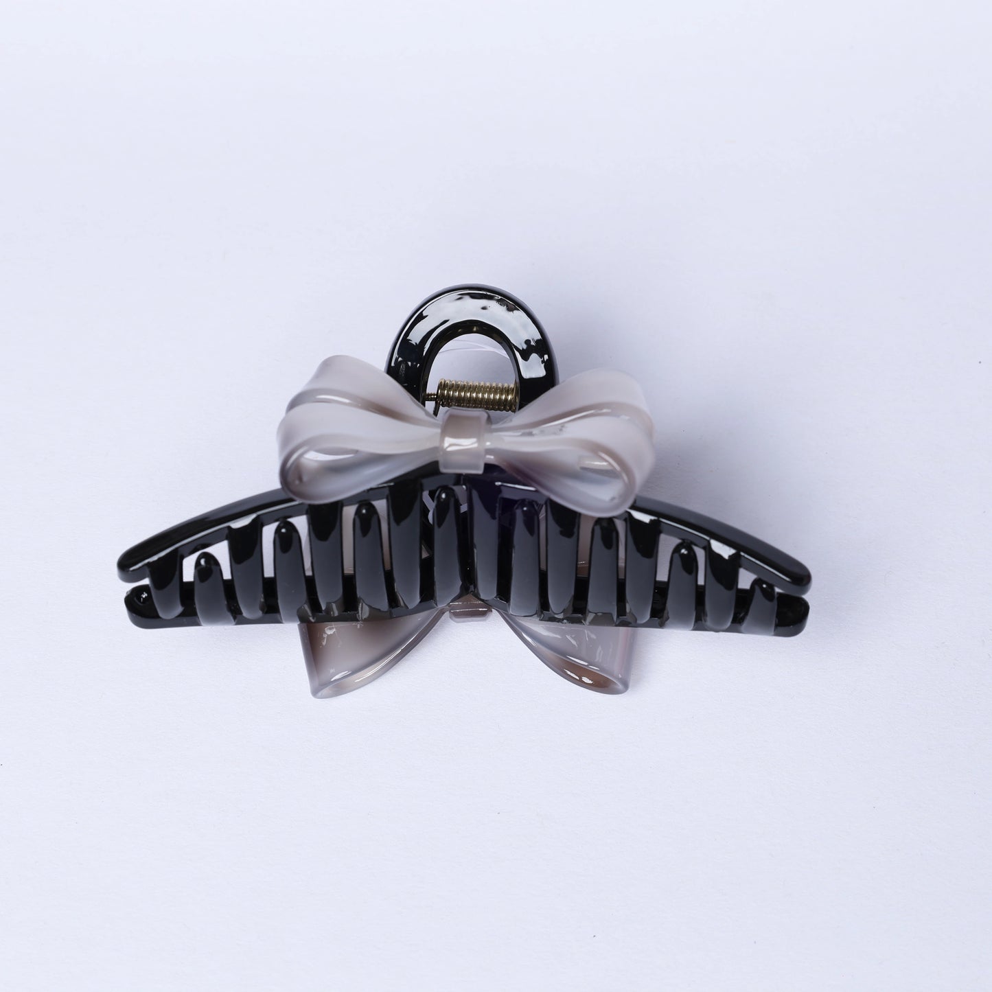 Black plastic hair claw clip with a translucent bow detail from Bow hair Clutches by mydevelopmentstor