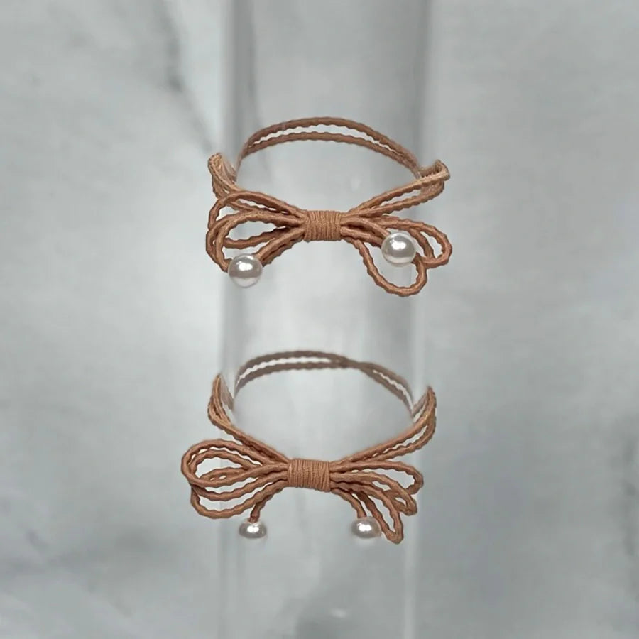 Brown bow hair ties for women with pearl accents perfect for stylish hair styling