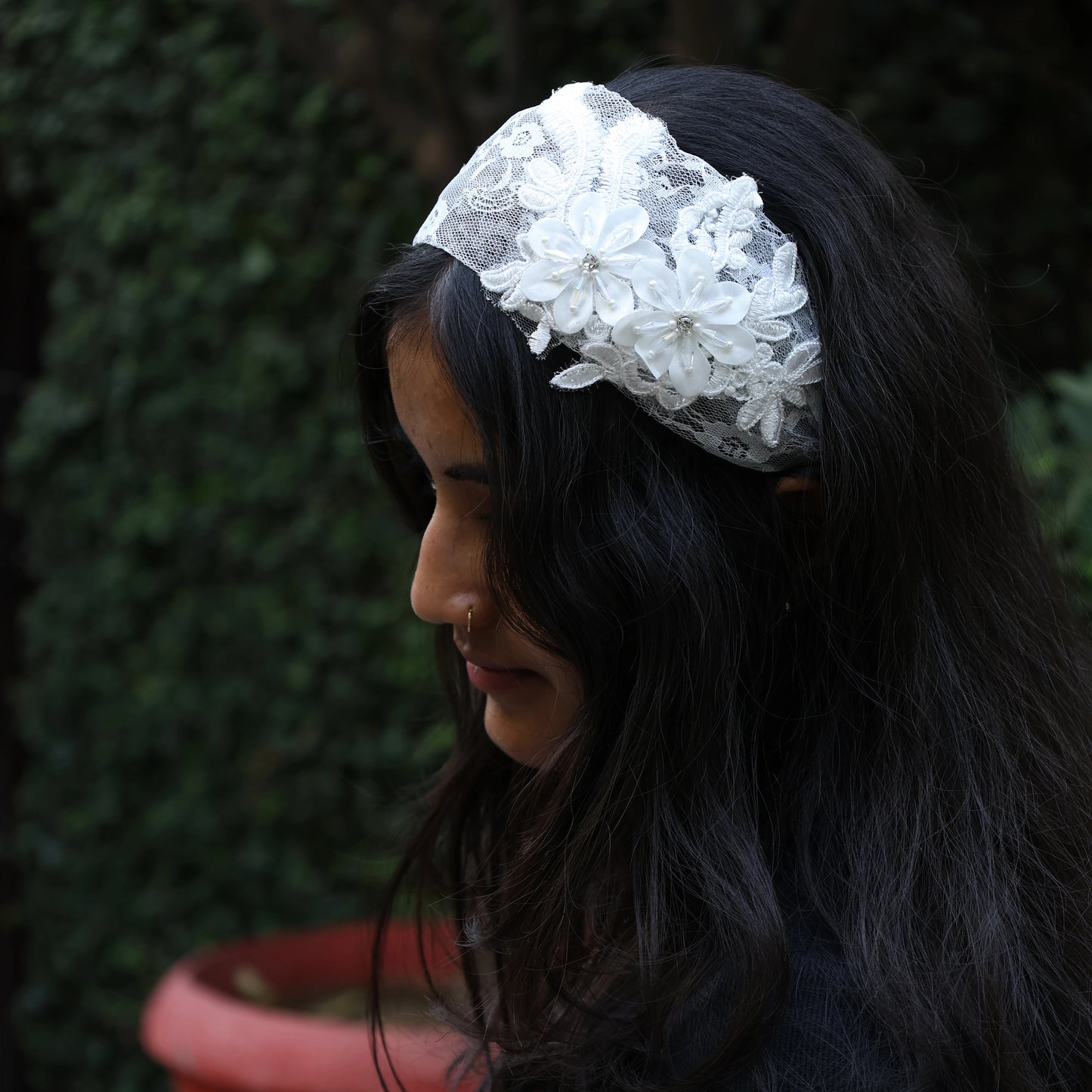 White lace broad flower hairbands worn on dark hair with intricate floral design
