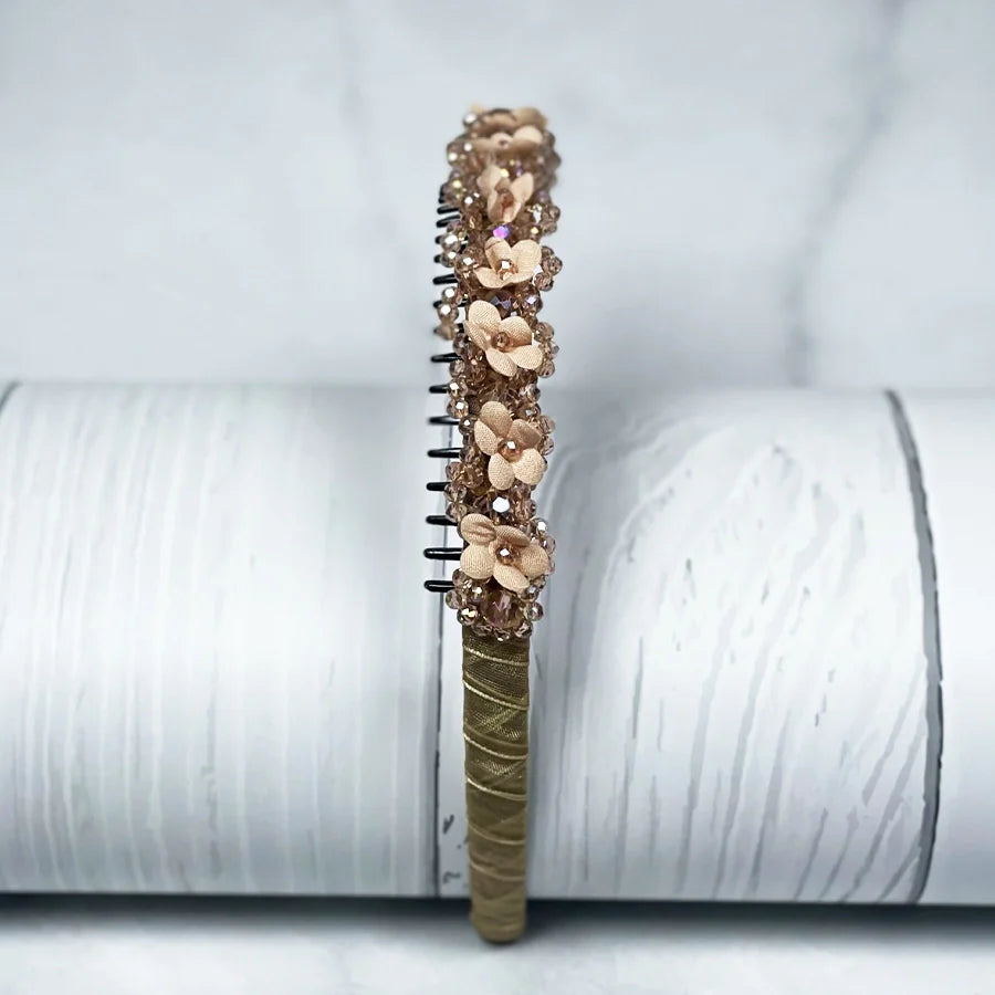 Brown embellished headbands for women with flower and bead decorations on a white background