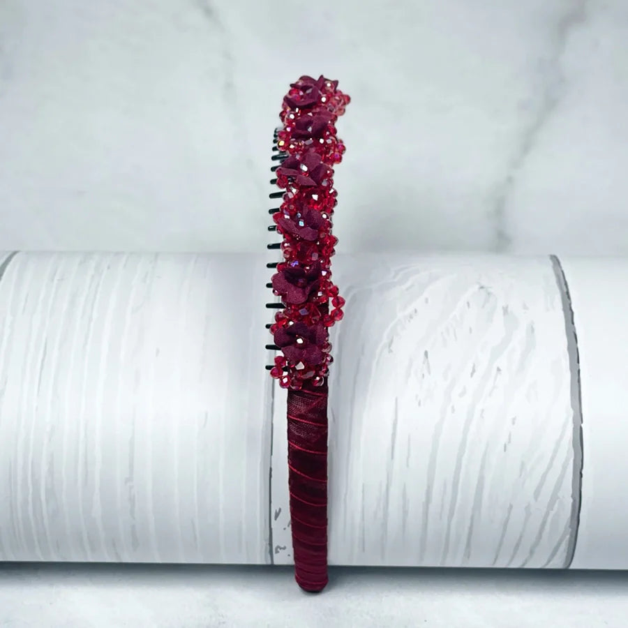 Red embellished headbands for women with floral and bead details on a fabric base