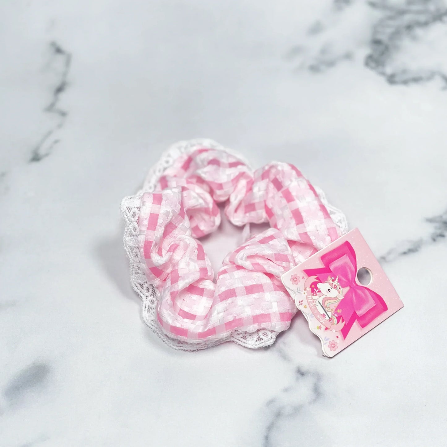 Pink and white check scrunchies with lace trim laid on marble surface from mydevelopmentstor