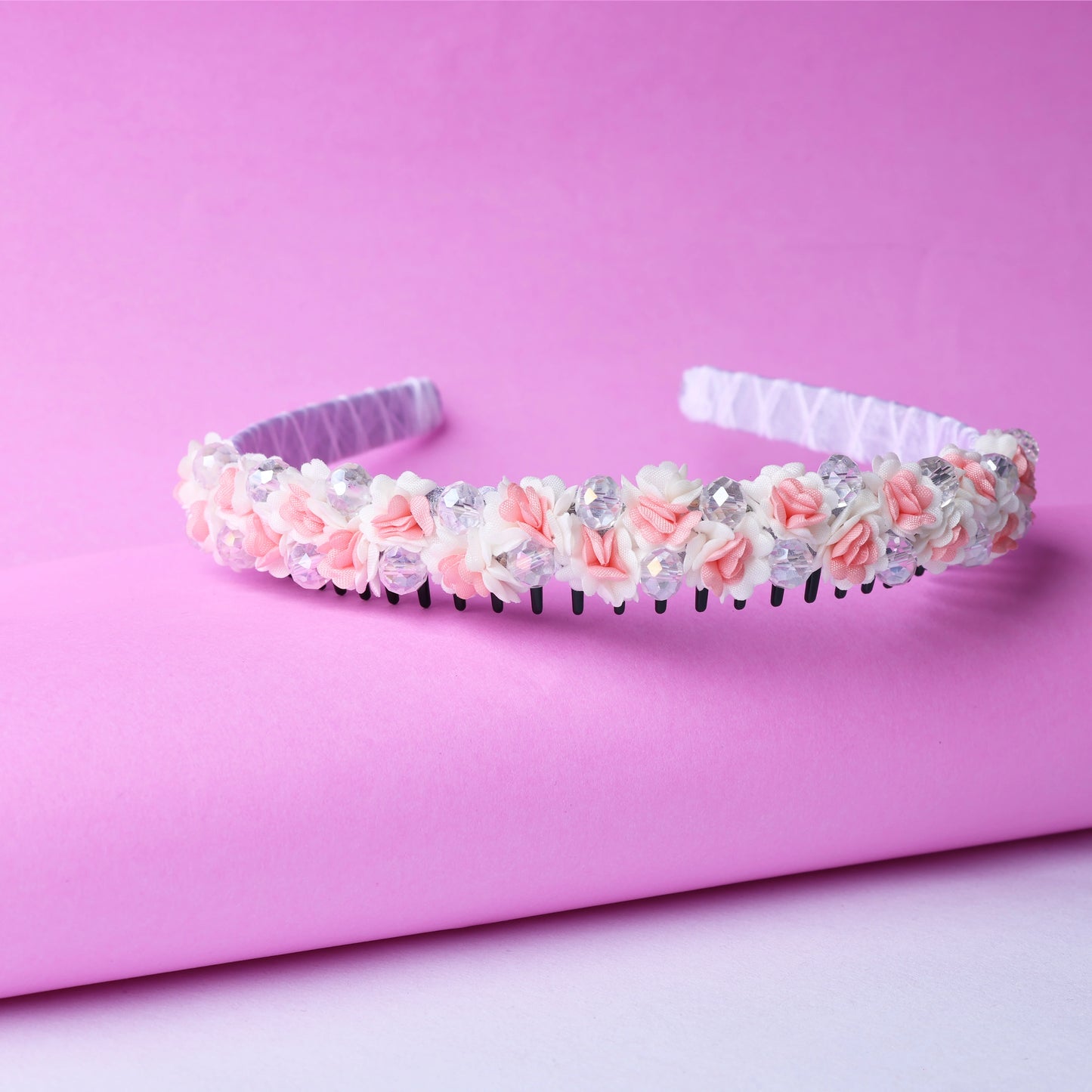 Pink and white crystal flower studded hairbands with delicate floral design on soft pink background