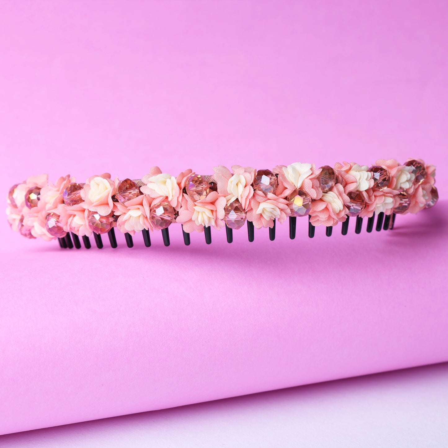 Pink crystal flower studded hairbands with delicate floral design on black plastic base