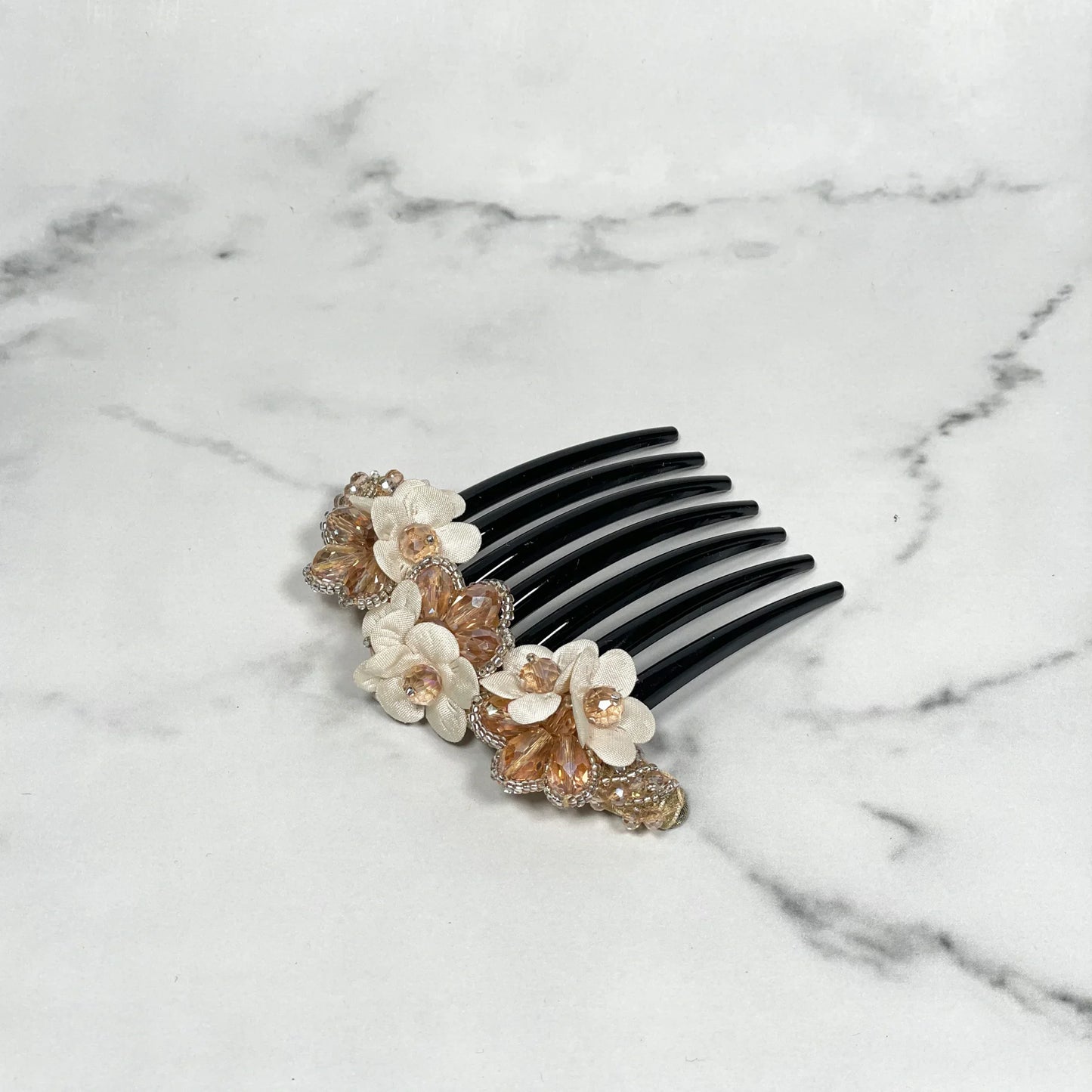 Black hair comb with crystal studded comb clips featuring white and amber flower decorations