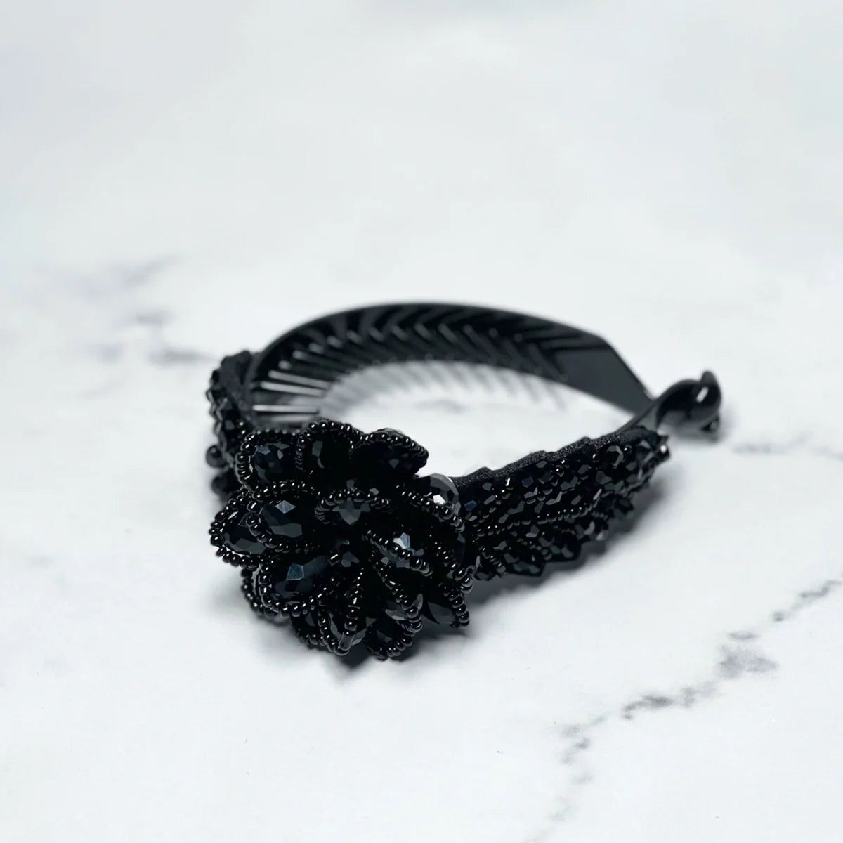 Black crystal studded hair bun clip with intricate flower design for stylish hair styling