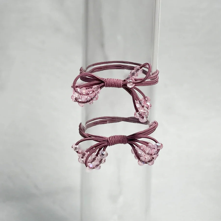 Set of two pink crystal studded hair ties bow with delicate beads on elastic bands