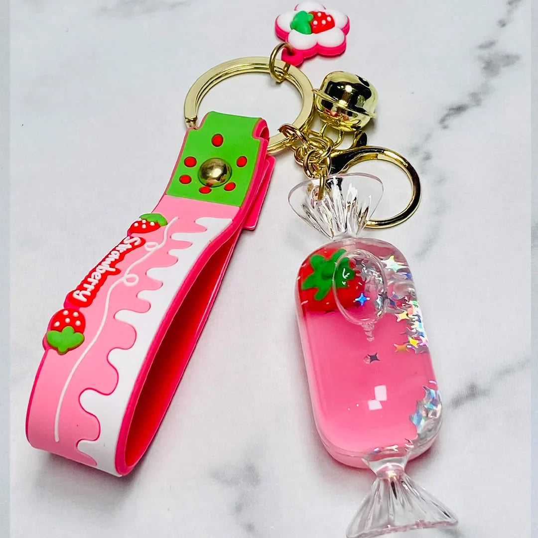 Fancy key chain with strawberry design and pink candy charm with gold rings and bell