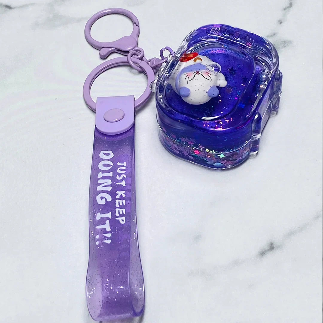 Purple fancy key chain with a cute white sleeping bear inside a glittery resin charm and a strap that says Just Keep Doing It