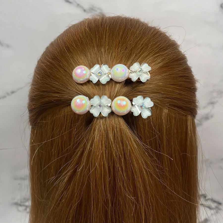 Fancy pearl flower hair pins arranged on red-brown hair with pearl and flower design