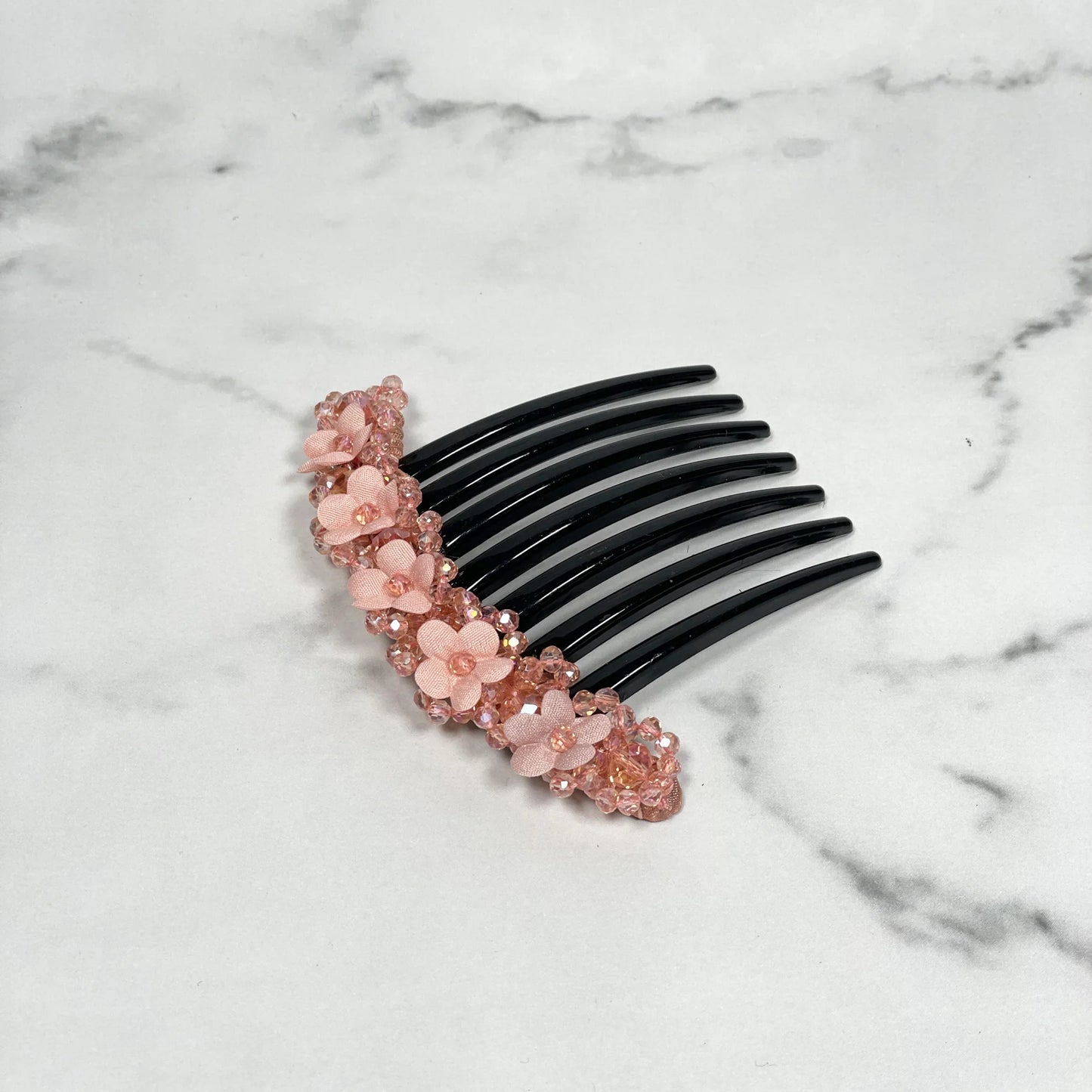 Pink floral beaded hair comb clips with decorative flowers on black comb base