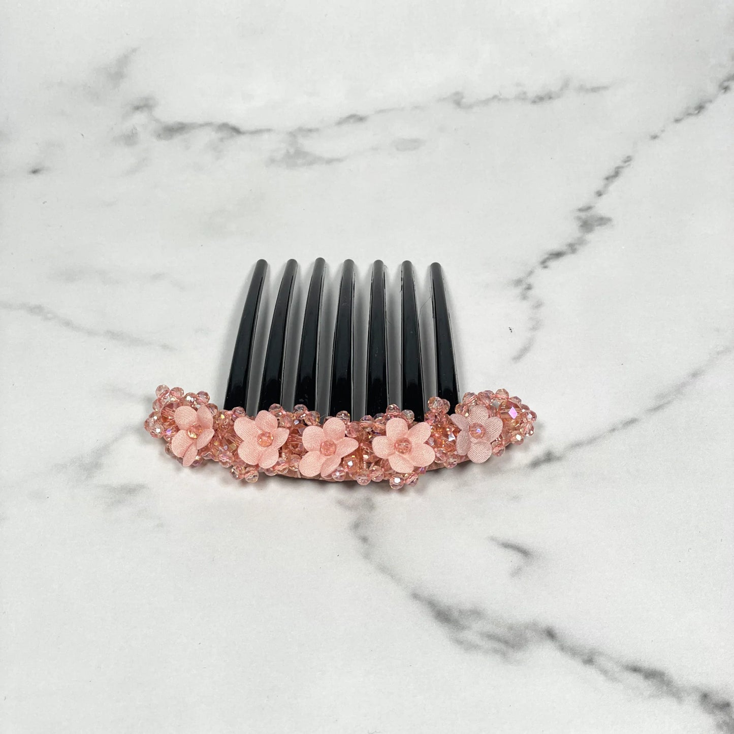 Black hair comb clip decorated with pink floral beaded hair comb clips featuring delicate flower designs