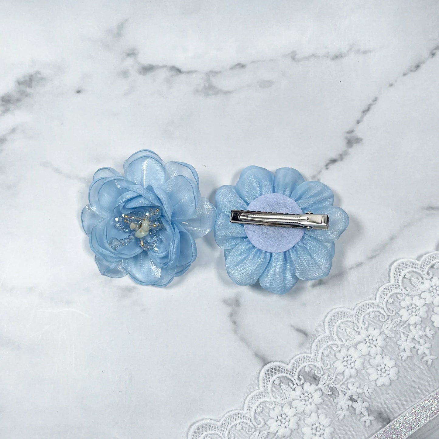 Blue floral organza hair pins with delicate layered petals and metal clip backing