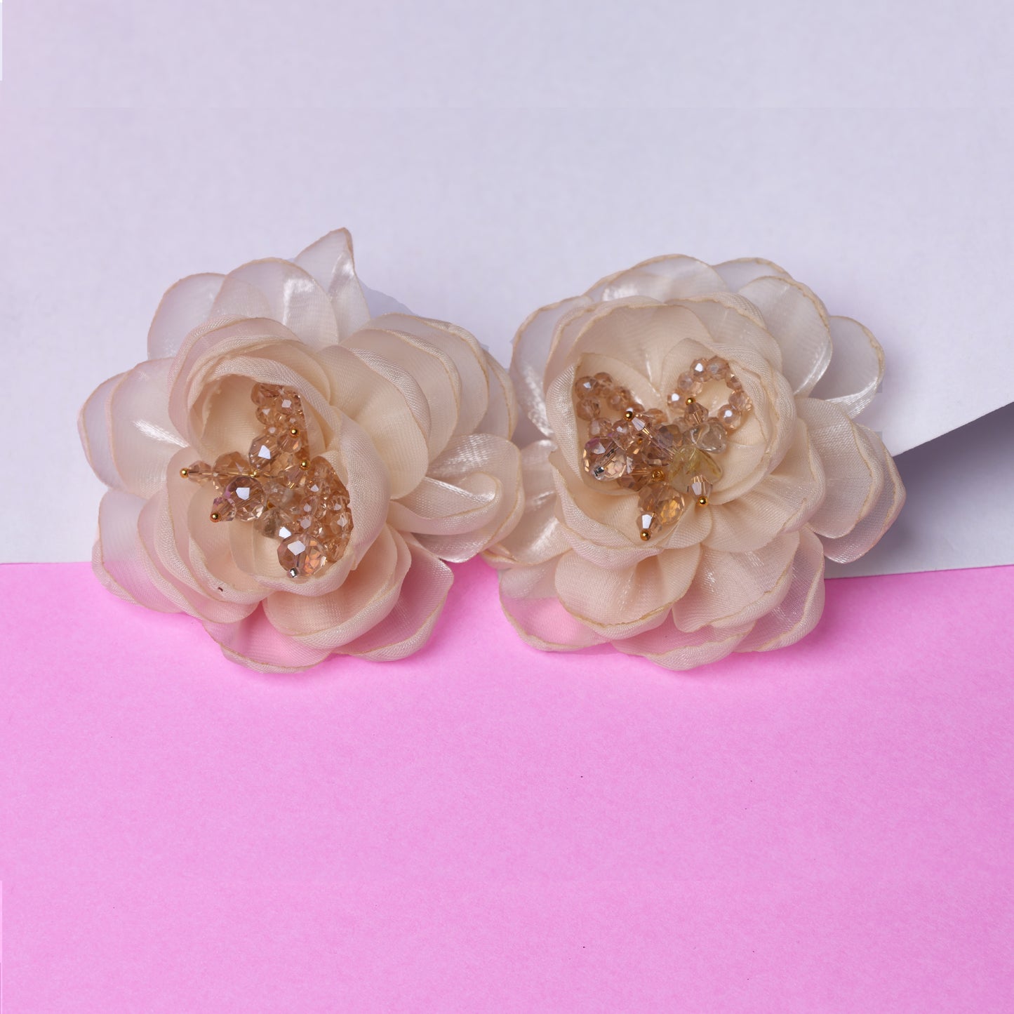 Pair of elegant floral organza hair pins with beige petals and decorative gold embellishments