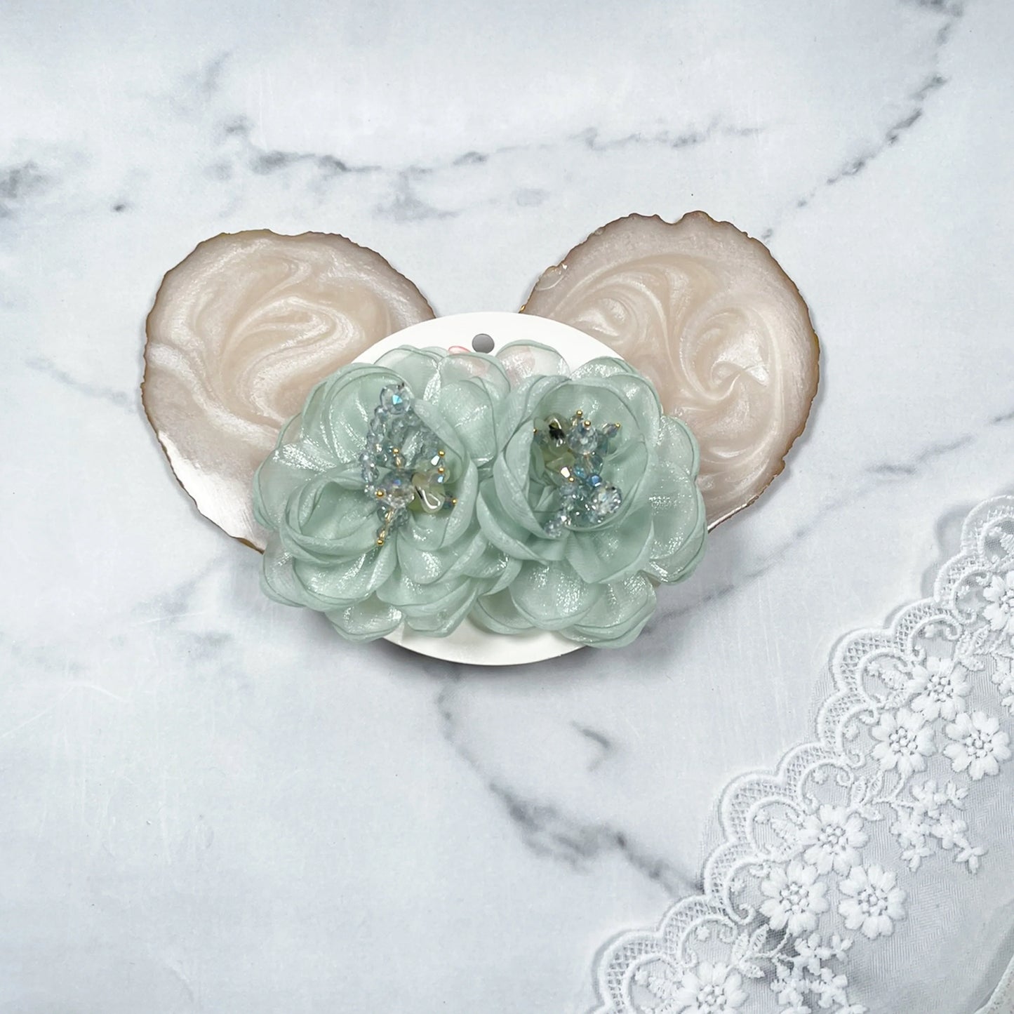 Delicate floral organza hair pins in light green with bead embellishments on white card
