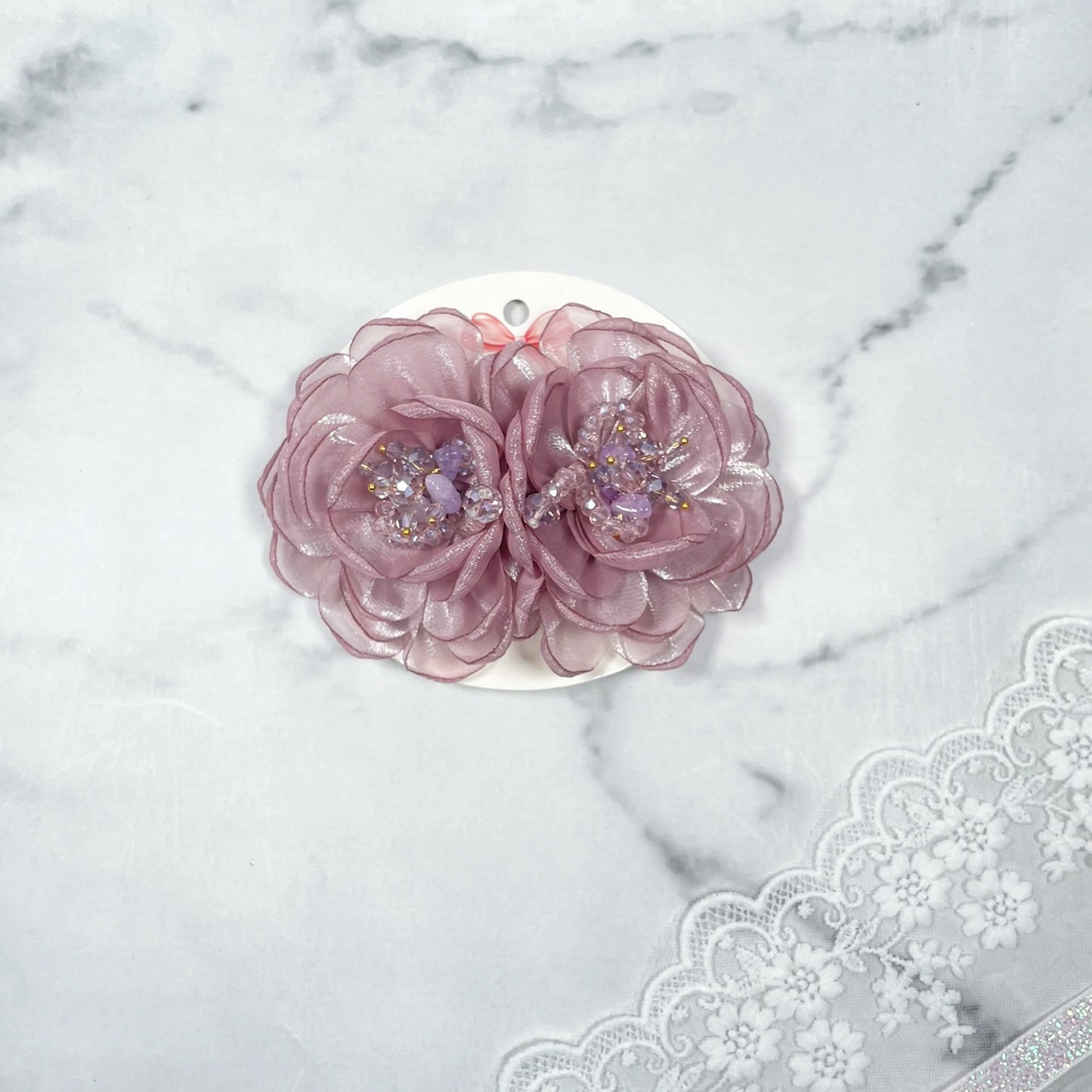 Two pink floral organza hair pins with delicate bead embellishments on white card