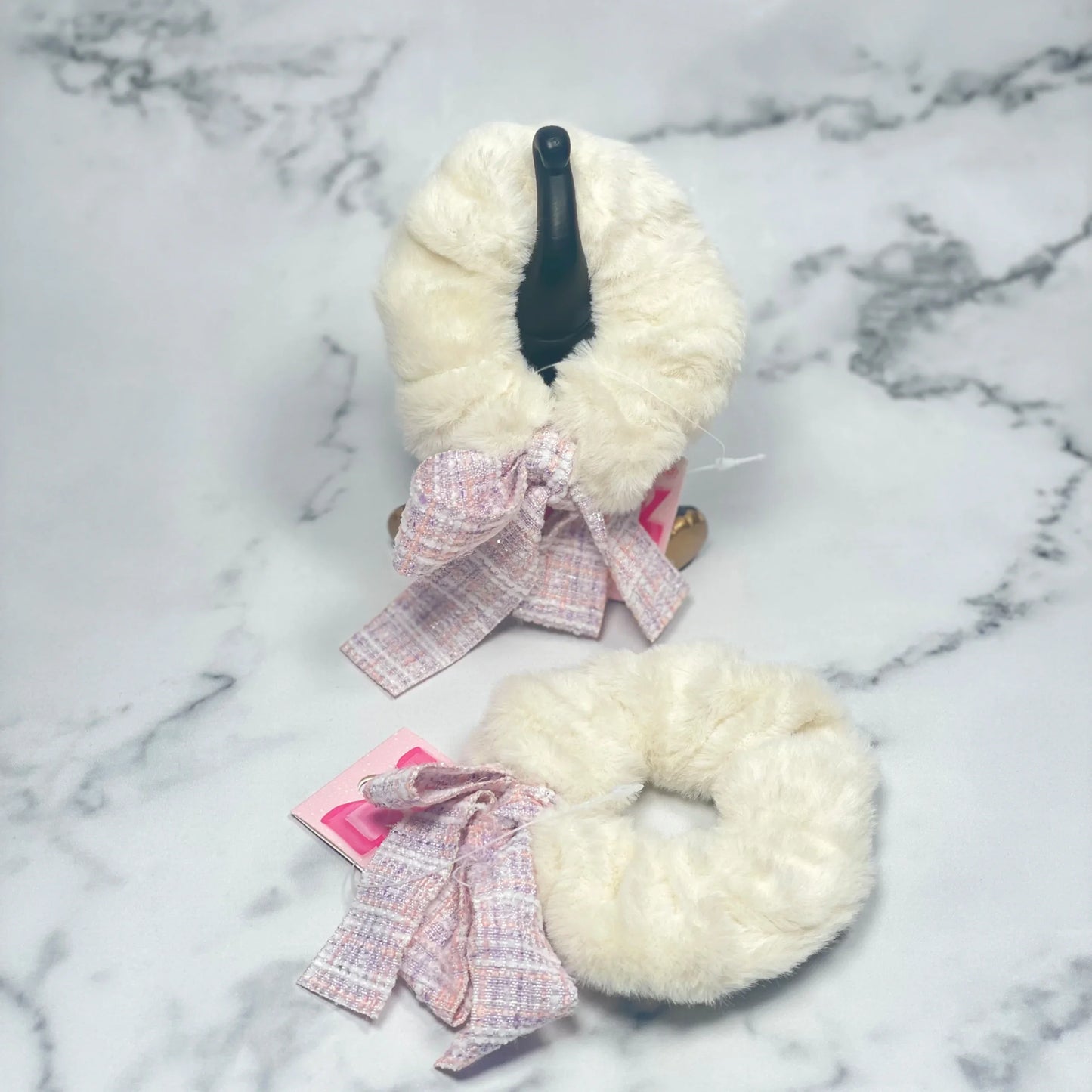 Soft white fur scrunchie with check ribbon tied in a bow for stylish hair accessory