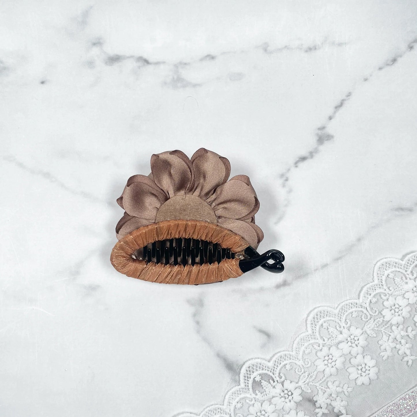 Bella Luxe simple hair clip with brown fabric flower on marble surface without golden crystal banana clip