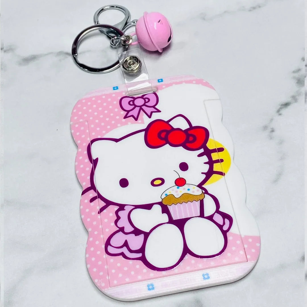 Pink Hello Kitty key chains with name tags featuring a cupcake and a small bell charm