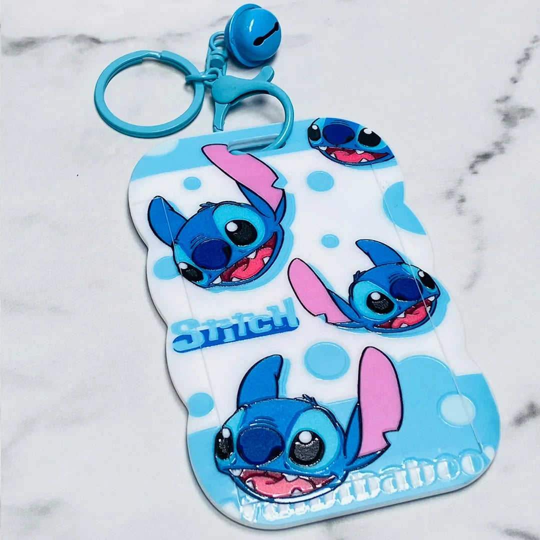 Blue Stitch key chains with name tags featuring multiple cartoon faces and a blue bell charm
