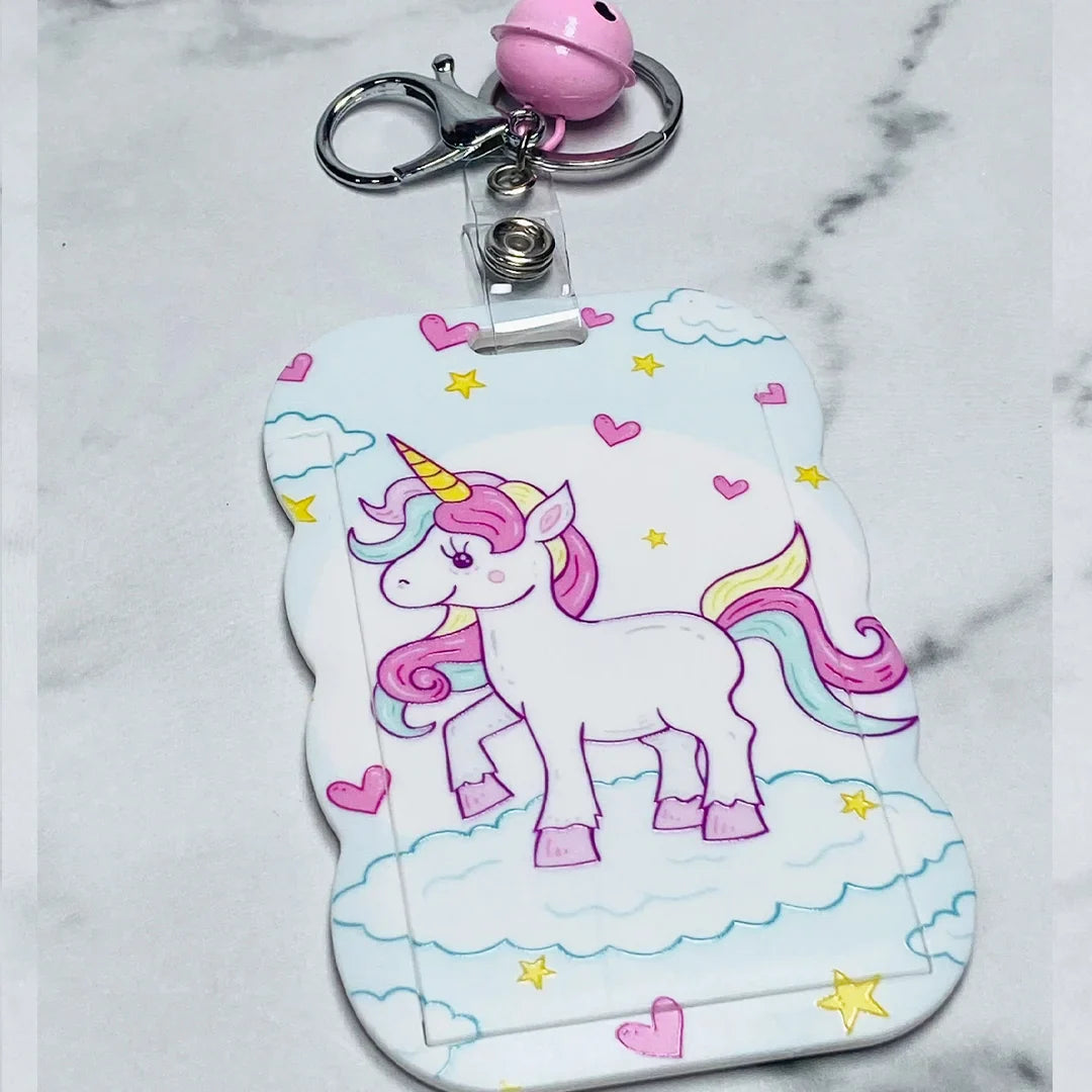 Cute unicorn key chains with name tags featuring pink bell and cloud background design