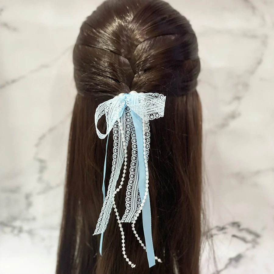 Blue lace satin pearl hair ties styled on dark brown hair half-up hairstyle