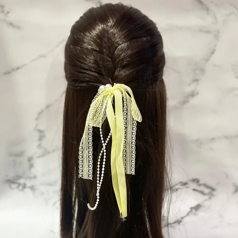 Lace satin pearl hair ties in pale yellow with delicate lace and pearl strands on dark brown hair