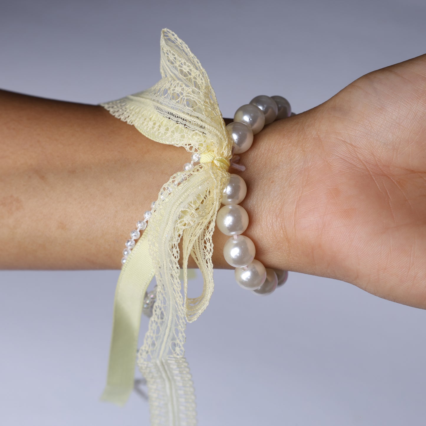 Lace satin pearl hair ties featuring delicate lace and satin ribbon with pearl beads on wrist