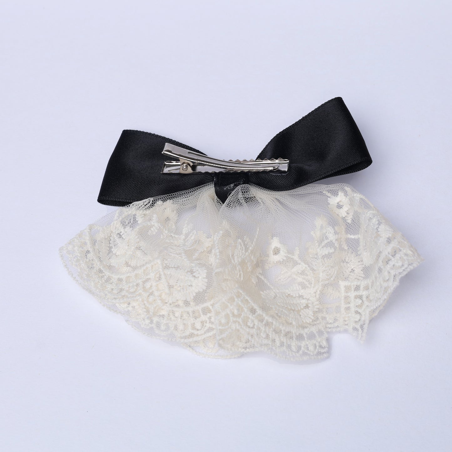 Lacy bow frill alligator clip featuring black satin bow and white lace frill detailing
