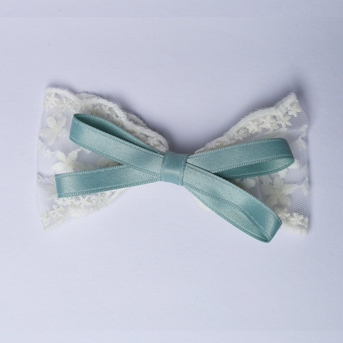 Lacy Bows with Ribbon featuring white lace and a teal satin ribbon tied in a bow