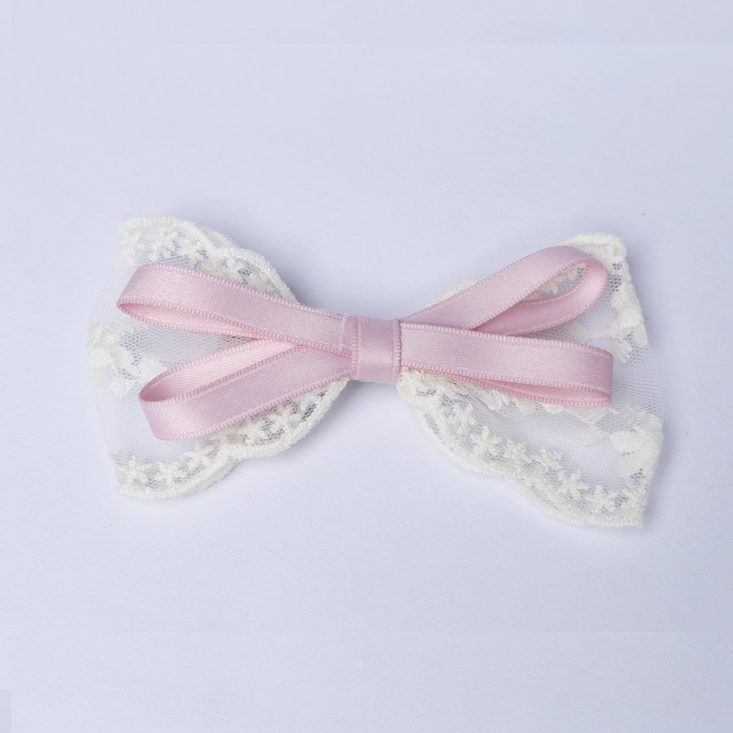 Pink satin and white lace Lacy Bows with Ribbon on a light background