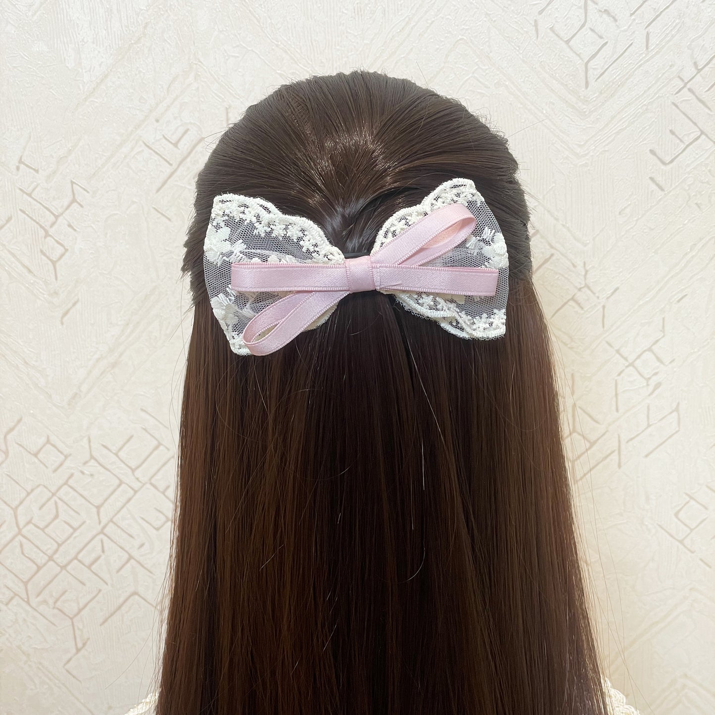 Lacy Bows with Ribbon hair accessory featuring delicate lace and pink ribbon on brown hair