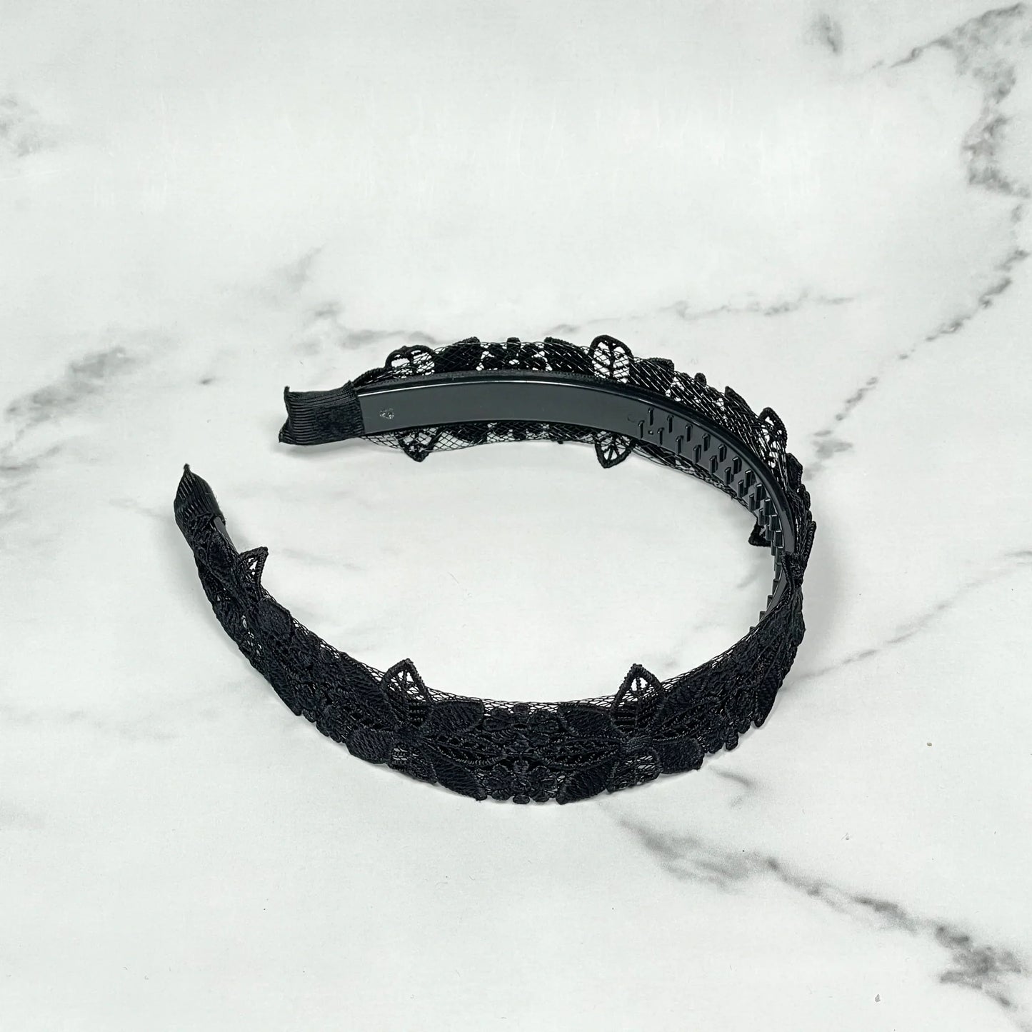 Black medium broad colored hair bands with lace design on marble background