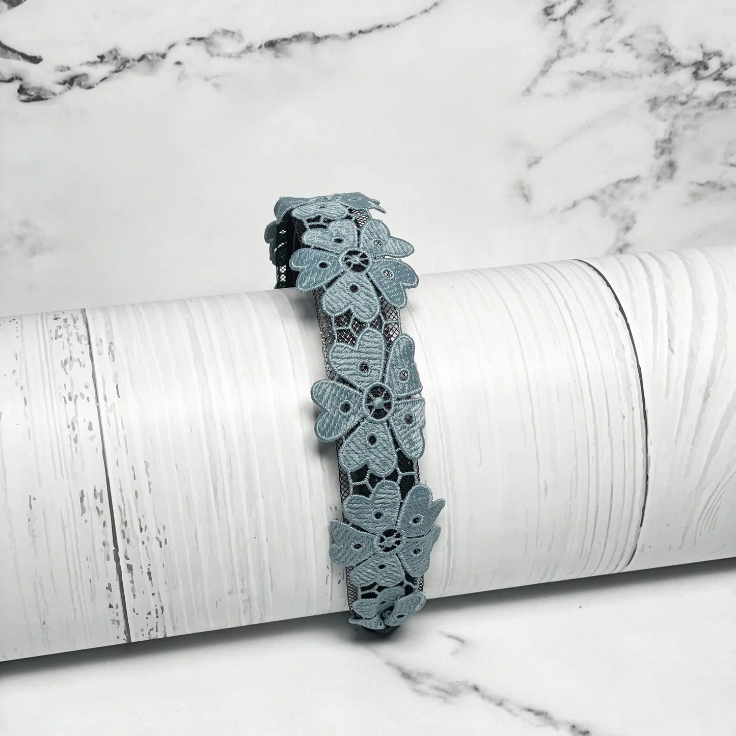 Medium Broad Lacy Floral Hairbands in blue with intricate flower lace design on white background