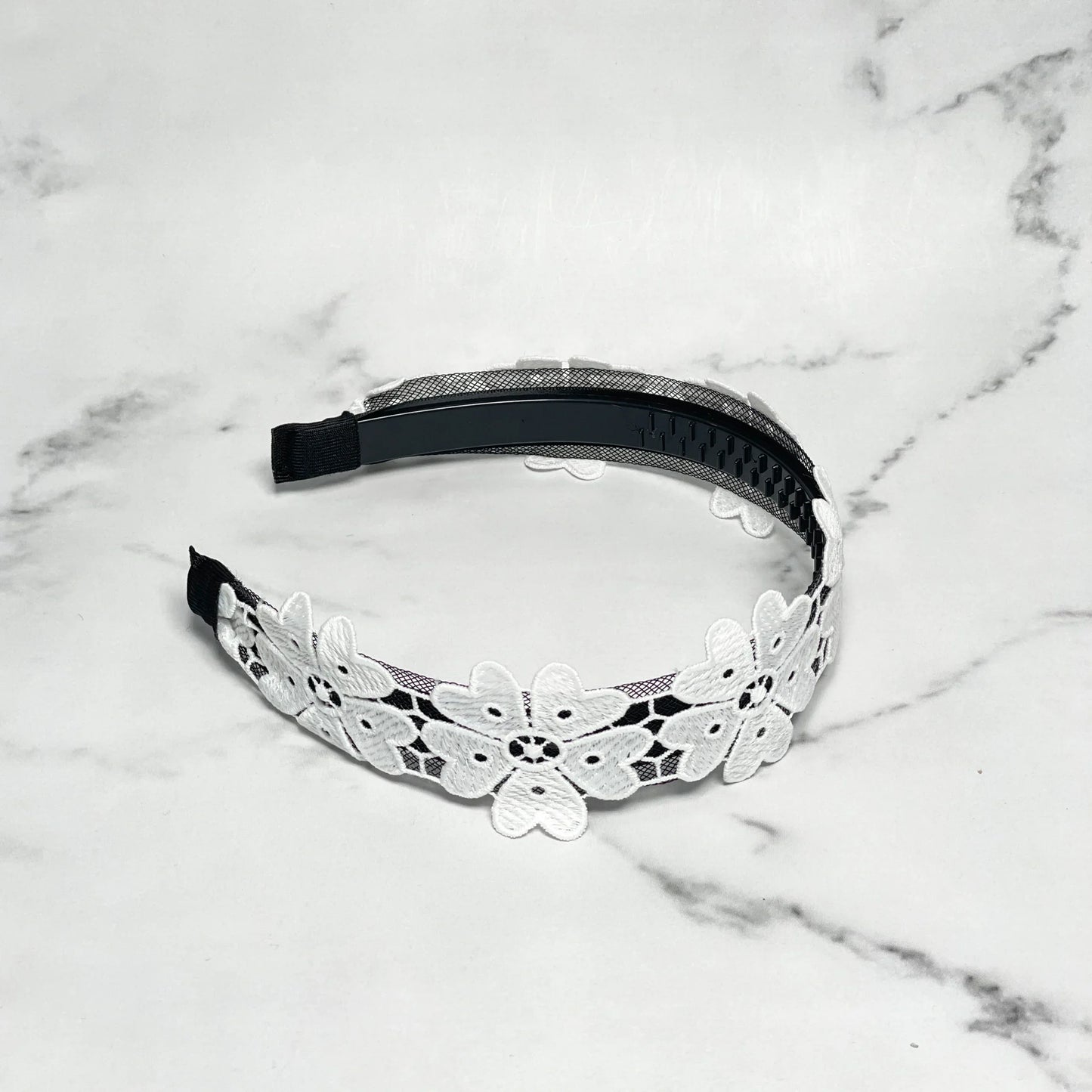 Black hairband adorned with white floral lace design Medium Broad Lacy Floral Hairbands