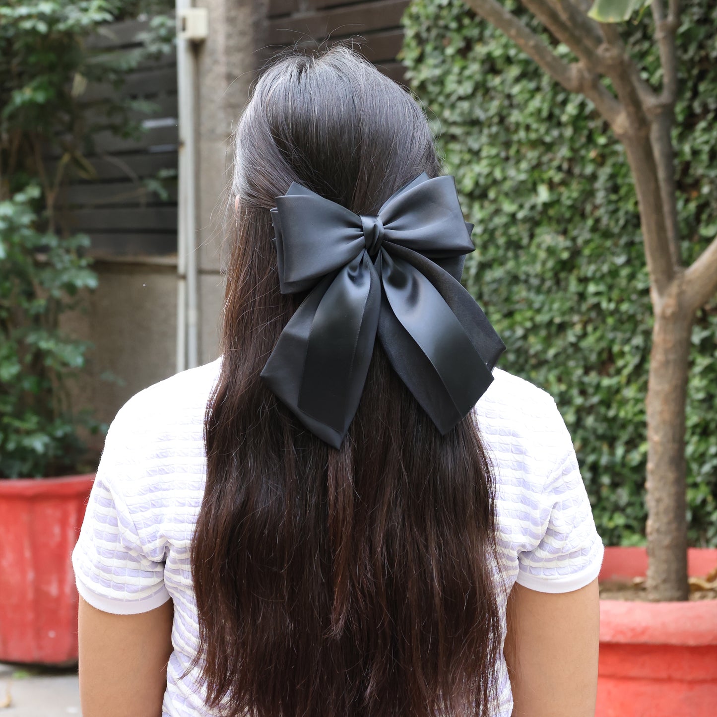 Black Organza and Satin Bow Clips worn in long dark hair, perfect for elegant hairstyles