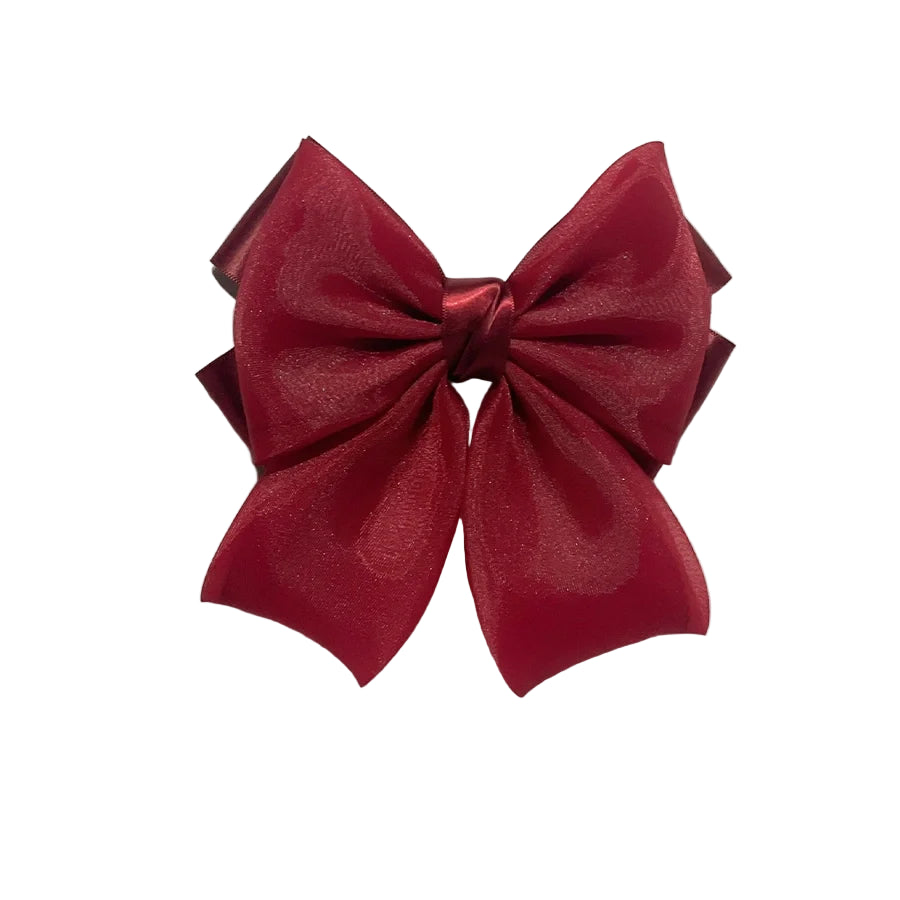 Red organza satin bow hair clips with layered design on white marble background