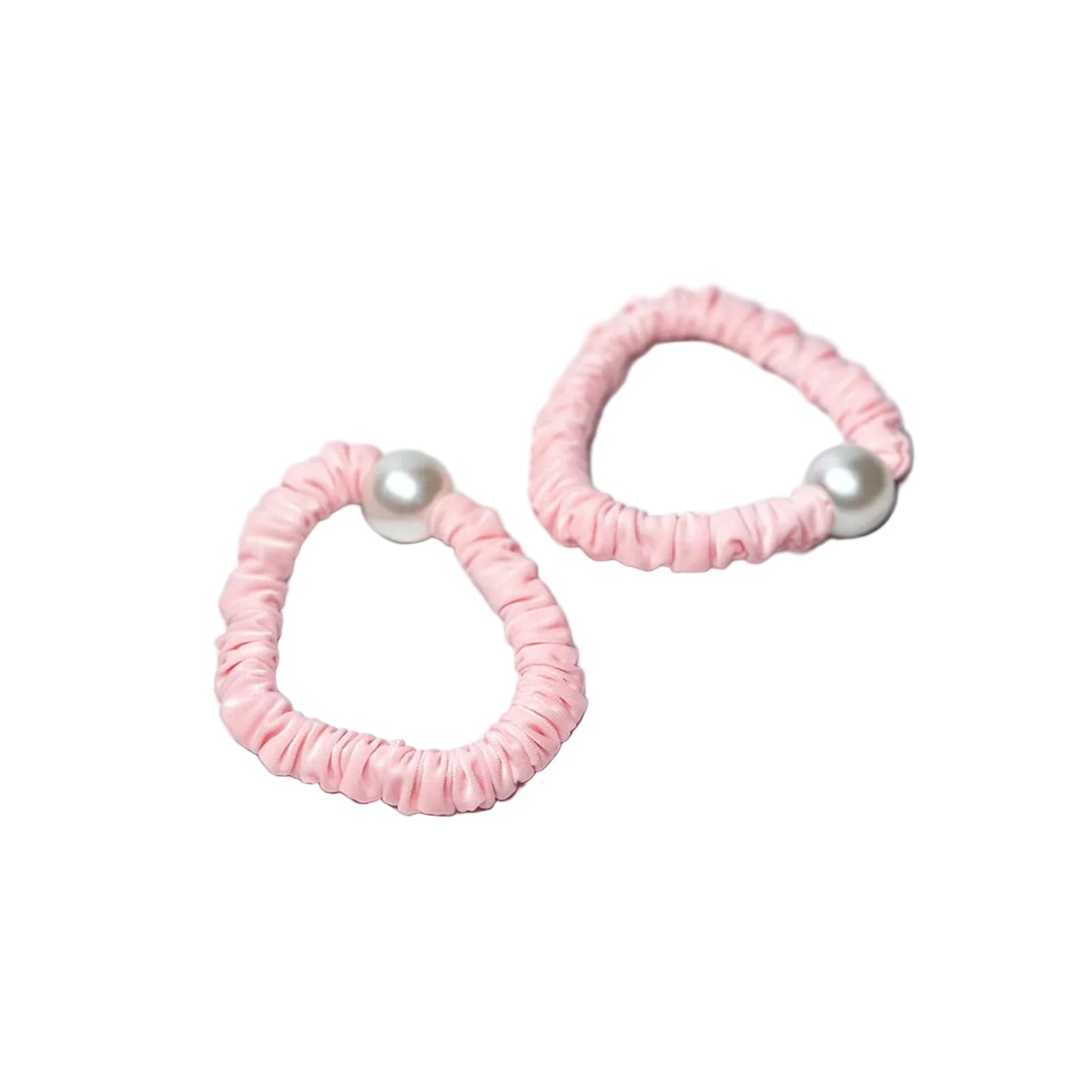 Pink pastel hair ties with pearl detail on a marble surface for stylish hair accessories