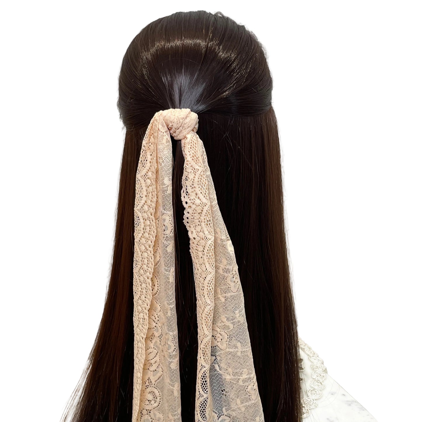 Bella Luxe peach lacy hair scarf tied in long dark hair with intricate lace pattern