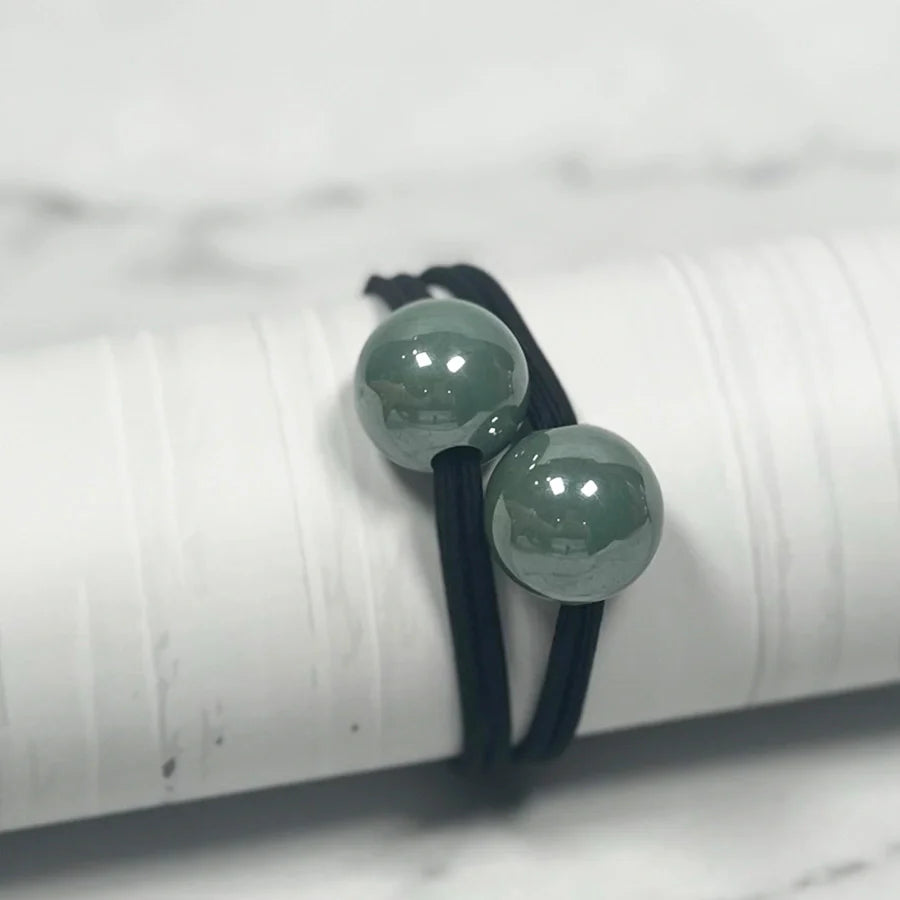 Black elastic hair ties with large glossy green pearl bead hair ties for stylish hair accessories