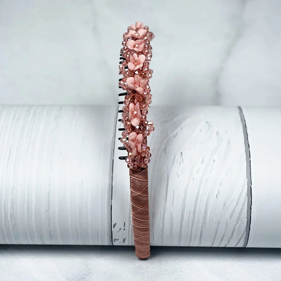 Pink embellished headbands for women with floral and bead details on a wrapped base