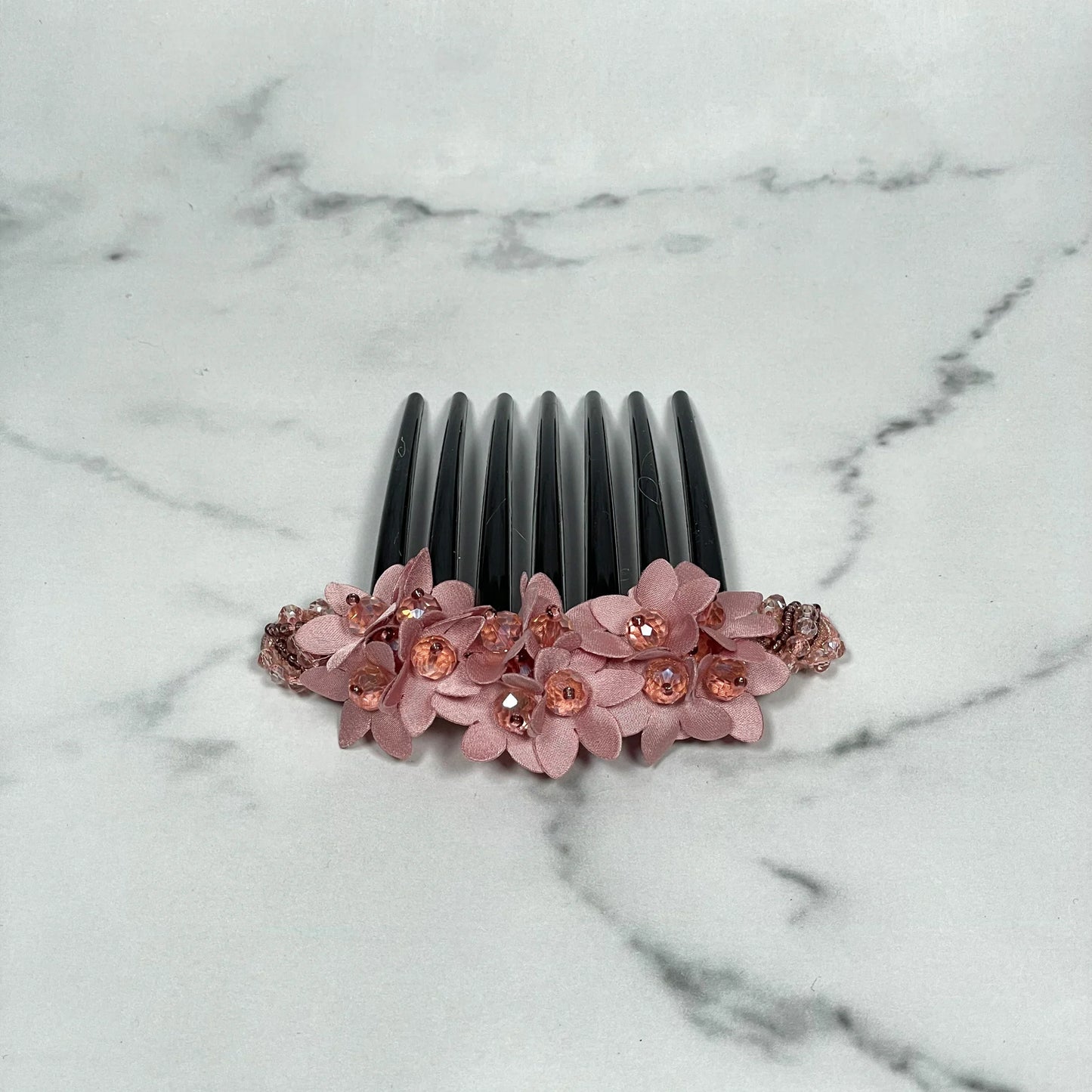Pink floral studded hair bun comb with gemstones on black teeth for elegant hairstyles