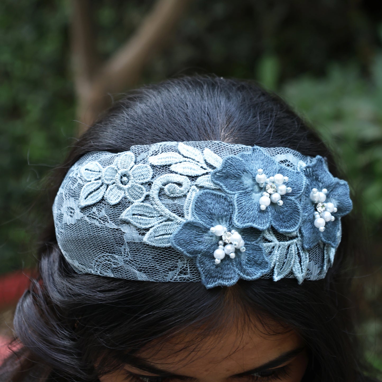 Blue lace three flower broad hairbands with pearl accents worn on dark hair
