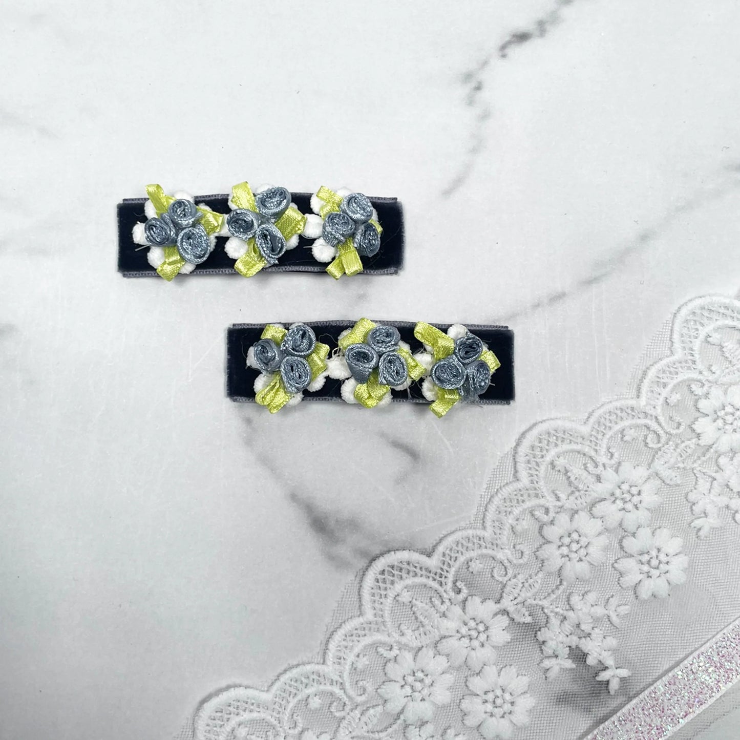 Set of velvet flower hair pins with blue velvet roses and yellow ribbon accents on black base