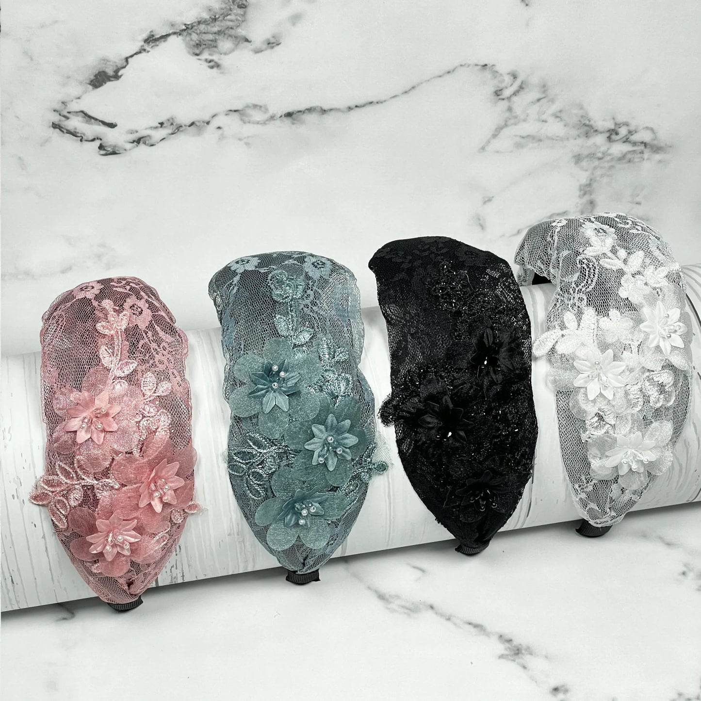 Set of broad shimmery lacy hairbands in pink, teal, black, and white with floral designs