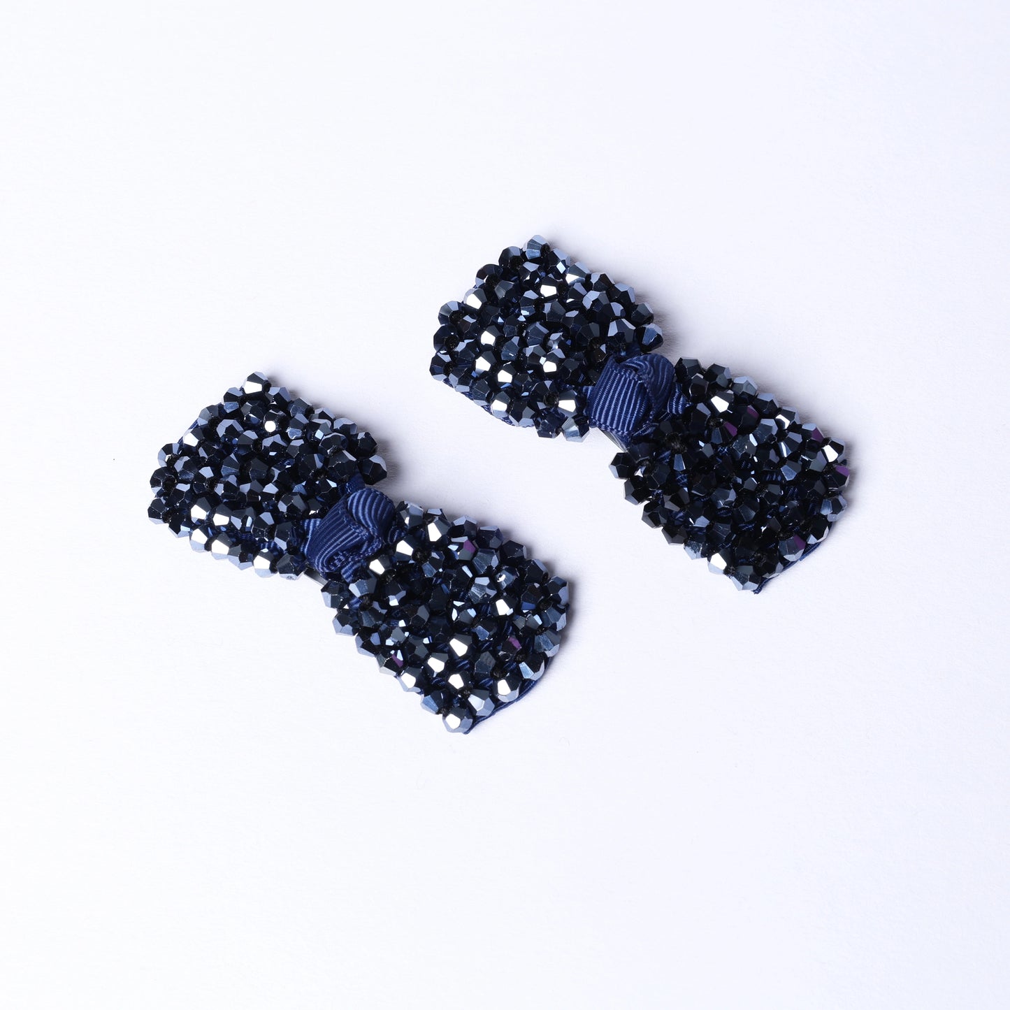 Pair of black crystal bow hair pins adorned with sparkling beads for elegant hair styling