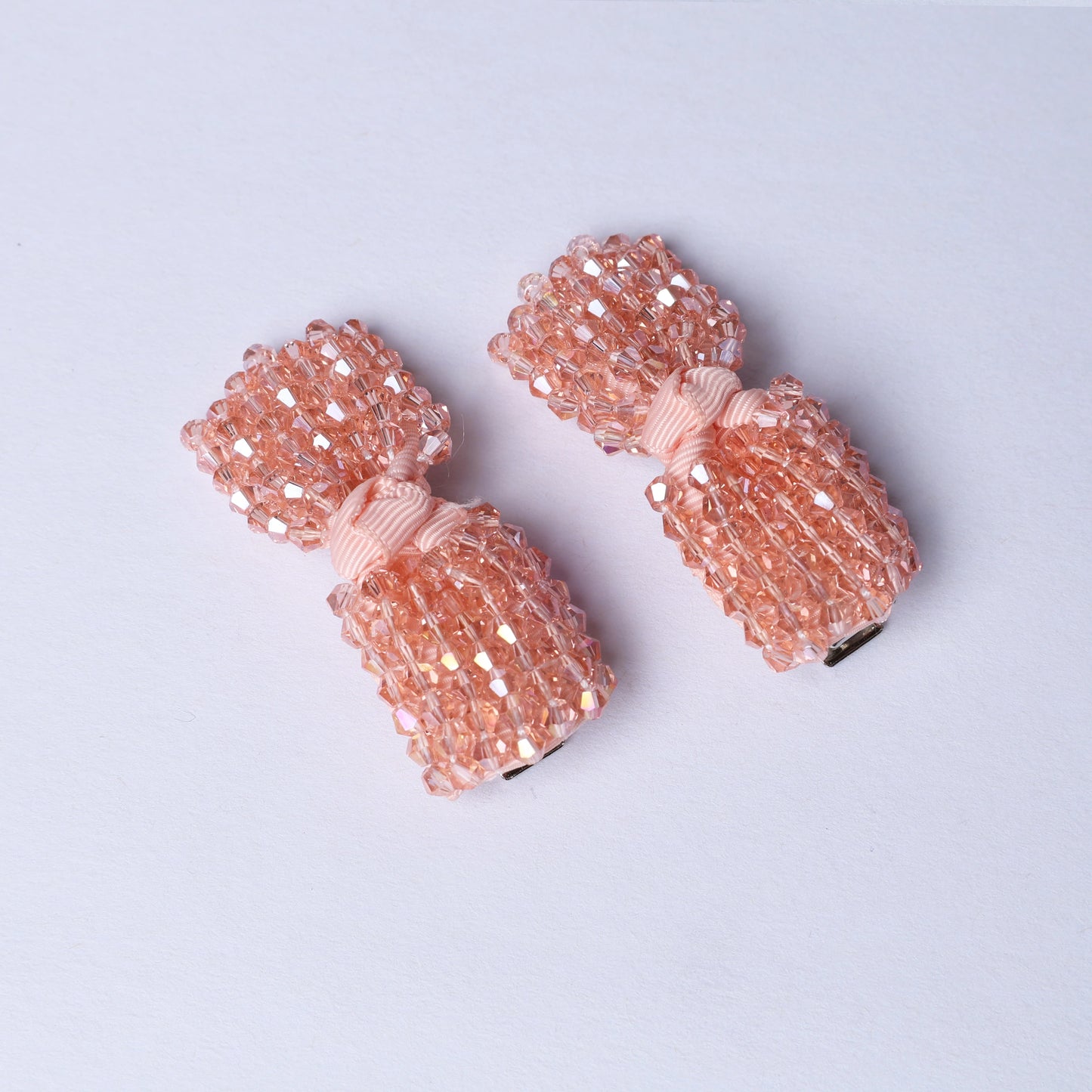 Pink beaded crystal bow hair pins with a delicate ribbon detail for stylish hair accessories